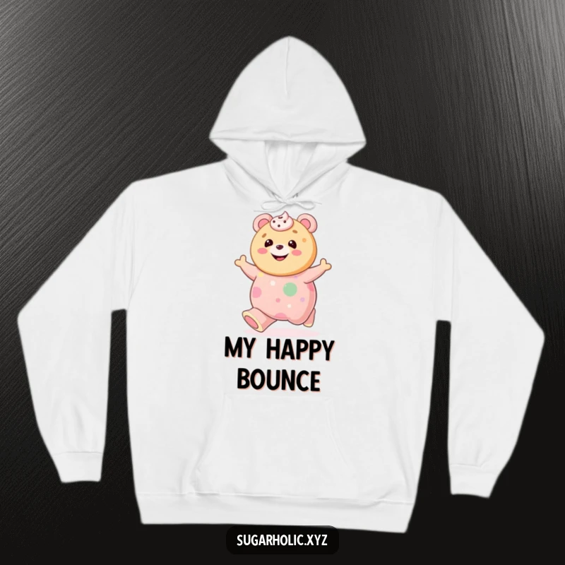 Funny cookie with frosting smile bouncing on a giant gummy bear, featured on a hoodie for cozy, humorous wear.