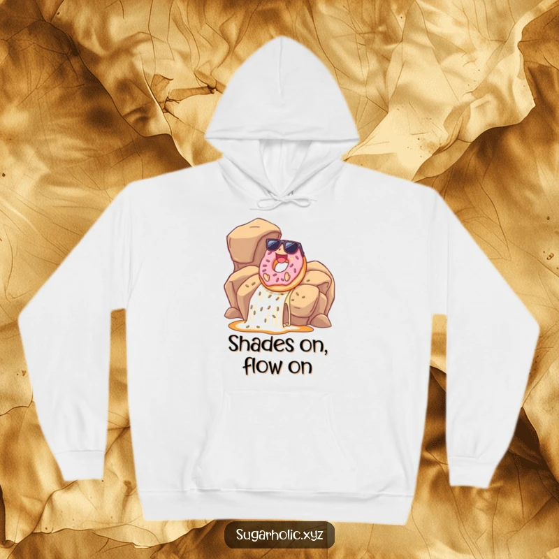 Funny donut wearing sunglasses on a hoodie, joyfully sliding down a caramel waterfall, offering a cool and humorous look.